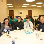 Guests smile over dinner